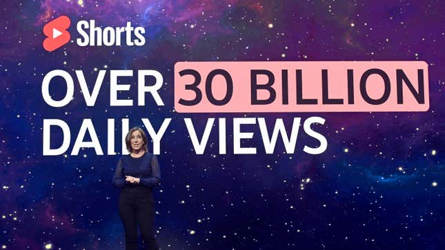 Susan Wojcicki stands in front of a sign that says Shorts over 30 billion daily views