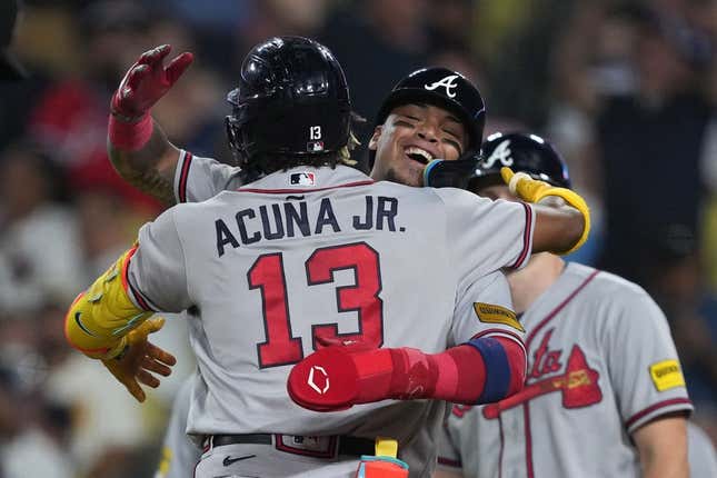 Aug 31, 2023; Los Angeles, California, USA; Atlanta Braves right fielder Ronald Acuna Jr. (13) is greeted after hitting a grand slam home run in the second inning against the Los Angeles Dodger at Dodger Stadium.
