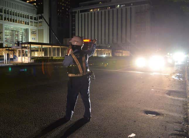 A police officer stands at a crossing following a blackout after a strong earthquake hit Sapporo.