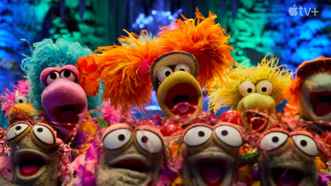 A group of brightly colored Fraggles sing together.