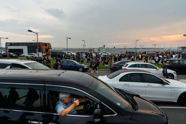 A man gestures his support for protesters heading to Hong Kong International Airport on Aug. 12, 2019.