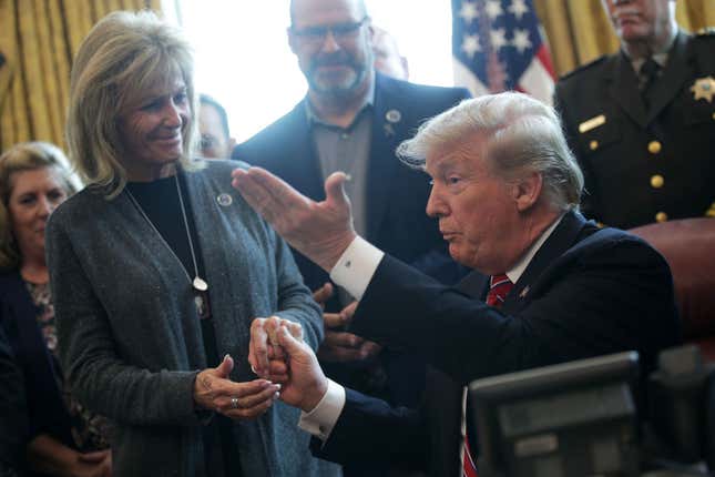 WASHINGTON, DC - MARCH 15: U.S. President Donald Trump (R) greets Angel Mom Mary Ann Mendoza (L) of Mesa, Arizona, during an event on border security in the Oval Office of the White House March 15, 2019, in Washington, DC. President Trump has vetoed the congressional resolution that blocks his national emergency declaration on the southern border.