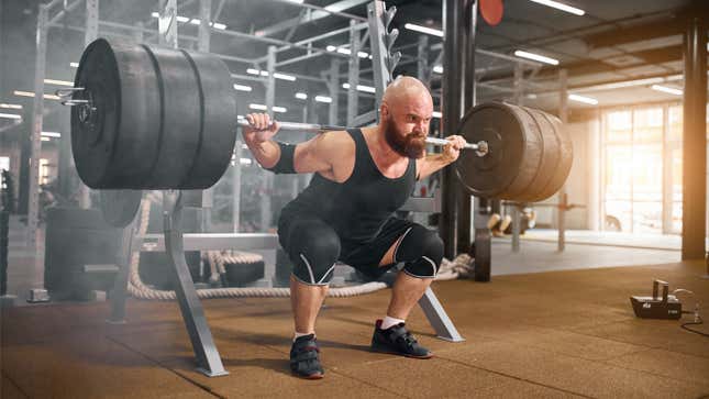man squatting while wearing knee sleeves and elbow sleeves