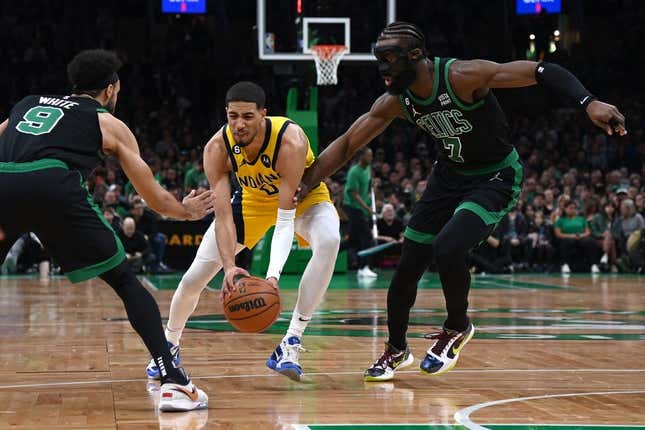 Mar 24, 2023; Boston, Massachusetts, USA;  Indiana Pacers guard Tyrese Haliburton (0) controls the ball while Boston Celtics guard Derrick White (9) and guard Jaylen Brown (7) defend during the first half at TD Garden.