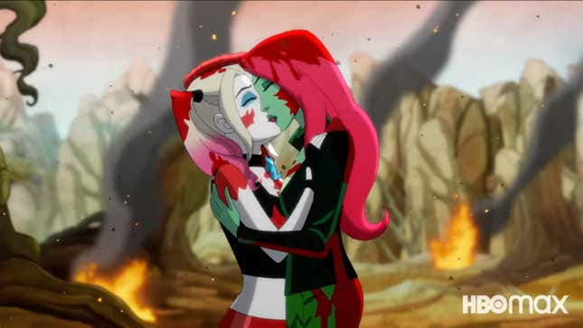 A blood-soaked Harley Quinn and Poison Ivy kiss on a flaming, smoking battlefield.