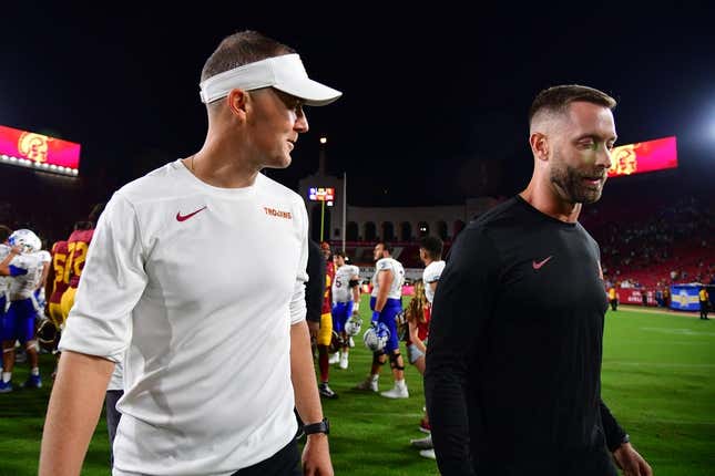 Aug 26, 2023; Los Angeles, California, USA; Southern California Trojans head coach Lincoln Riley speaks with assistant coach Kliff Kingsbury following the victory against the San Jose State Spartans at Los Angeles Memorial Coliseum.