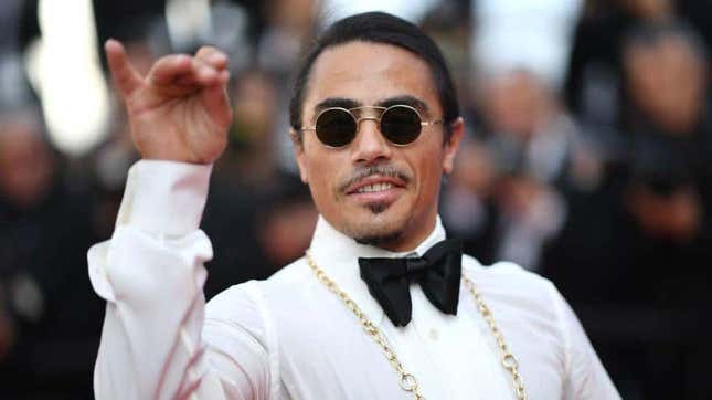 Salt Bae on the red carpet doing his salt sprinkle thing, but without any salt