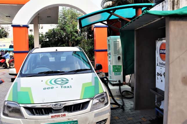 An EV commercial car being charged at a paid public charging point in Hyderabad.