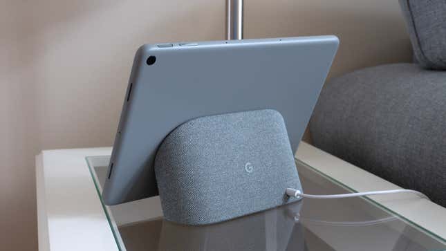 The back of the Google Pixel Tablet while connected to its dock, sitting on a small side table.
