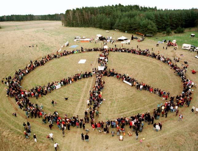 hippies holding hands in a peace sign