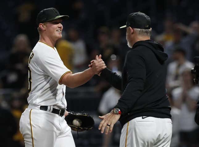 May 8, 2023; Pittsburgh, Pennsylvania, USA;  Pittsburgh Pirates starting pitcher Mitch Keller (23) is congratulated by manager Derek Shelton (right) after Keller pitched a complete game four hit shutout against the Colorado Rockies at PNC Park. The Pirates shutout the Rockies 2-0.