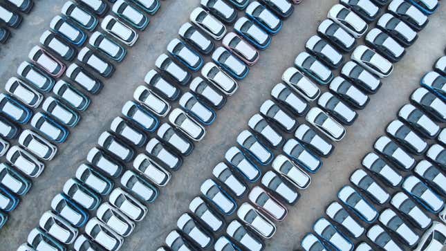An aerial photo of a parking lot full of brand new cars. 