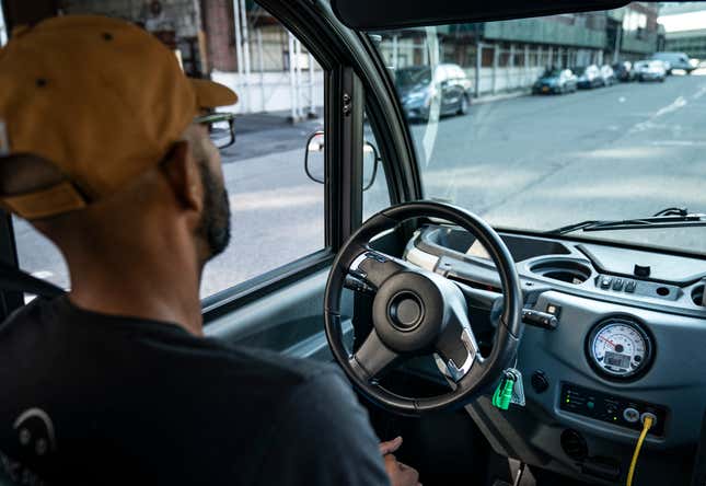 An Optimus Ride employee sits in the driver seat as he monitors the autonomous six-seater shuttle bus as it drives through the Brooklyn Navy Yard on August 15, 2019 in New York City. 