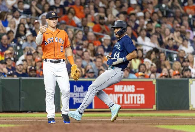 Aug 18, 2023; Houston, Texas, USA; Seattle Mariners center fielder Julio Rodriguez (44) runs from first base to third base on an error as Houston Astros third baseman Alex Bregman (2) awaits the throw in the seventh inning at Minute Maid Park.