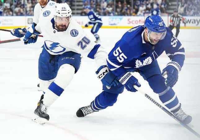 Apr 27, 2023; Toronto, Ontario, CAN; Tampa Bay Lightning left wing Nicholas Paul (20) battles with Toronto Maple Leafs defenseman Mark Giordano (55) during the third period in game five of the first round of the 2023 Stanley Cup Playoffs at Scotiabank Arena.