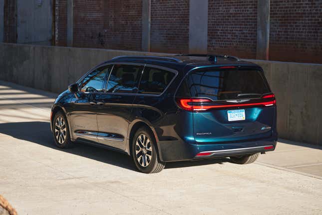 2023 Chrysler Pacifica Hybrid in teal, photographed next to a brick wall
