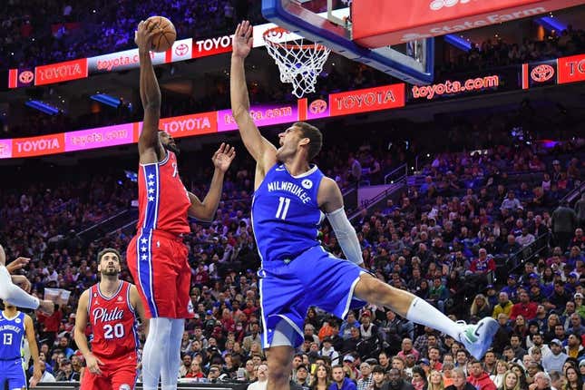 Nov 18, 2022; Philadelphia, Pennsylvania, USA; Philadelphia 76ers center Joel Embiid (21) grabs a rebound against Milwaukee Bucks center Brook Lopez (11) during the third quarter at Wells Fargo Center.