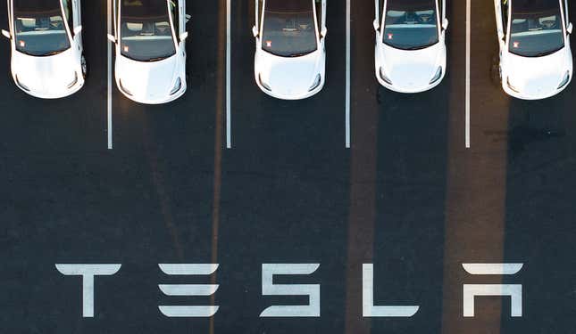 An aerial view shows cars parked at the Tesla Fremont Factory in Fremont, California on February 10, 2022. 