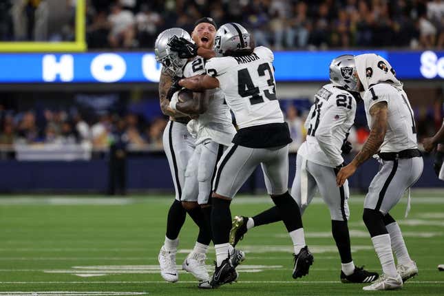 Aug 19, 2023; Inglewood, California, USA;  Las Vegas Raiders safety Isaiah Pola-Mao (20) celebrates with teammates after scoring a touchdown on an interception during the second quarter against the Los Angeles Rams at SoFi Stadium.