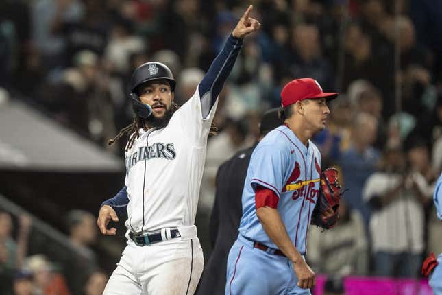 Apr 22, 2023; Seattle, Washington, USA; Seattle Mariners shortstop J.P. Crawford (3) gestures to third baseman Eugenio Suarez (28) after scoring a run during the seventh inning against the St. Louis Cardinals at T-Mobile Park.