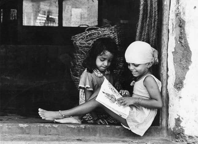 Museum number: PHY.07748 T. S. Satyan, Homework after bath, 1978, H. 23.4 cm, W. 30.2 cm, Silver gelatin print.