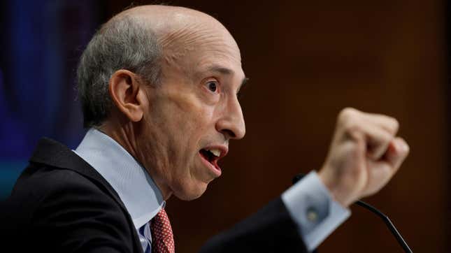 SEC Chairman Gary Gensler speaks at a congressional hearing, raising first and speaking in the photo