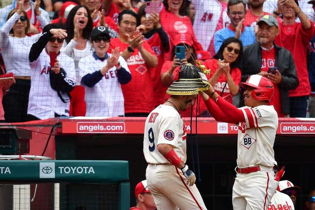 June 11, 2023; Anaheim, California, USA; Los Angeles Angels shortstop Zach Neto (9) receives the kabuto helmet after hitting a solo home run against the Seattle Mariners during the eighth inning at Angel Stadium.