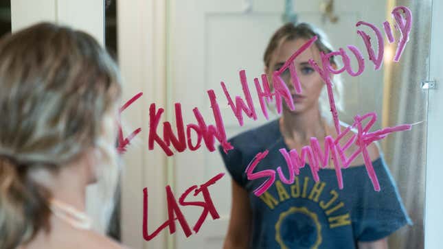 Madison Iseman stares as a message reading "I know what you did last summer" scrawled in lipstick on her mirror.