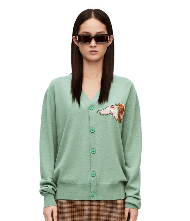 A screenshot of a green cardigan with the dog Heel over the chest.
