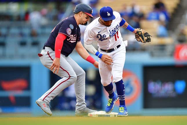 May 31, 2023; Los Angeles, California, USA; Washington Nationals designated hitter Joey Meneses (45) gets back to second against Los Angeles Dodgers shortstop Miguel Rojas (11) during the fifth inning at Dodger Stadium.