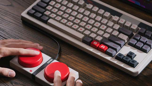 Fingers click on two giant red buttons. 