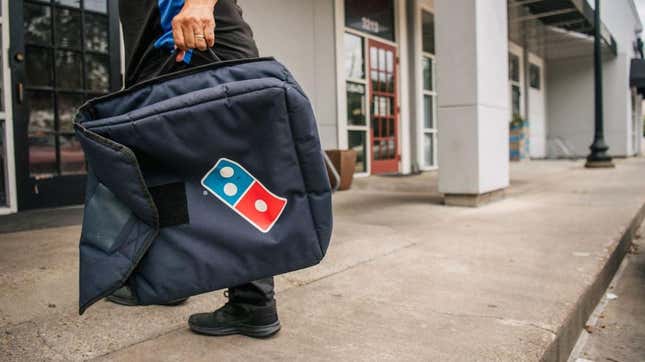 Domino's delivery driver holding bag