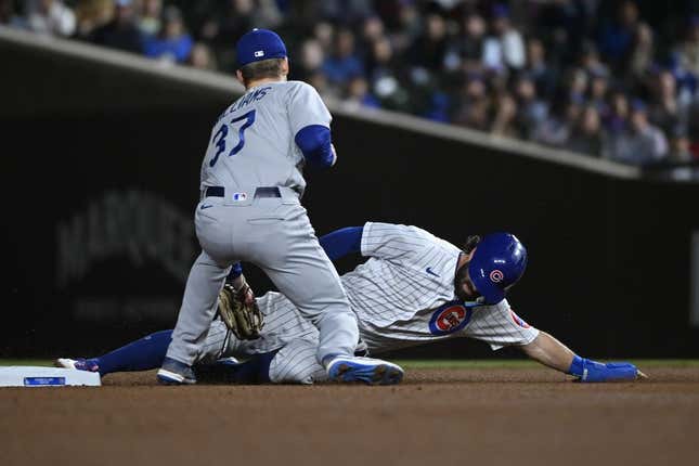 Apr 20, 2023; Chicago, Illinois, USA;  Chicago Cubs shortstop Dansby Swanson (7) slides safely into second base under Los Angeles Dodgers right fielder Luke Williams (37) during the first inning at Wrigley Field.
