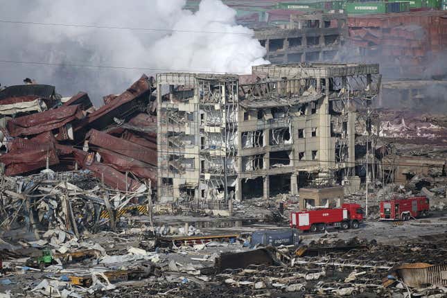 Crushed containers and burnt-out buildings.
