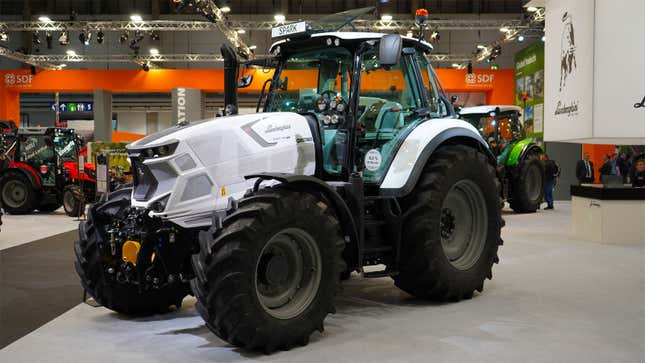 A photo of a white Lamborghini tractor at a trade show. 