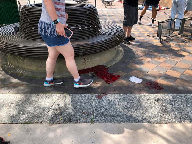 Blood pooled at Port Clinton Square in Highland Park, after a shooting  at a July Fourth parade, in a Chicago suburb, Monday, July 4, 2022.