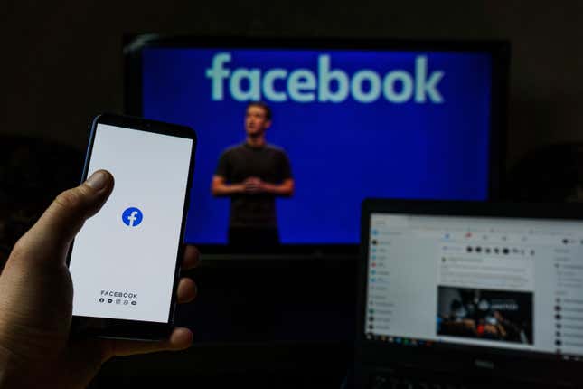 Facebook on laptop and phone, Mark Zuckerberg in background
