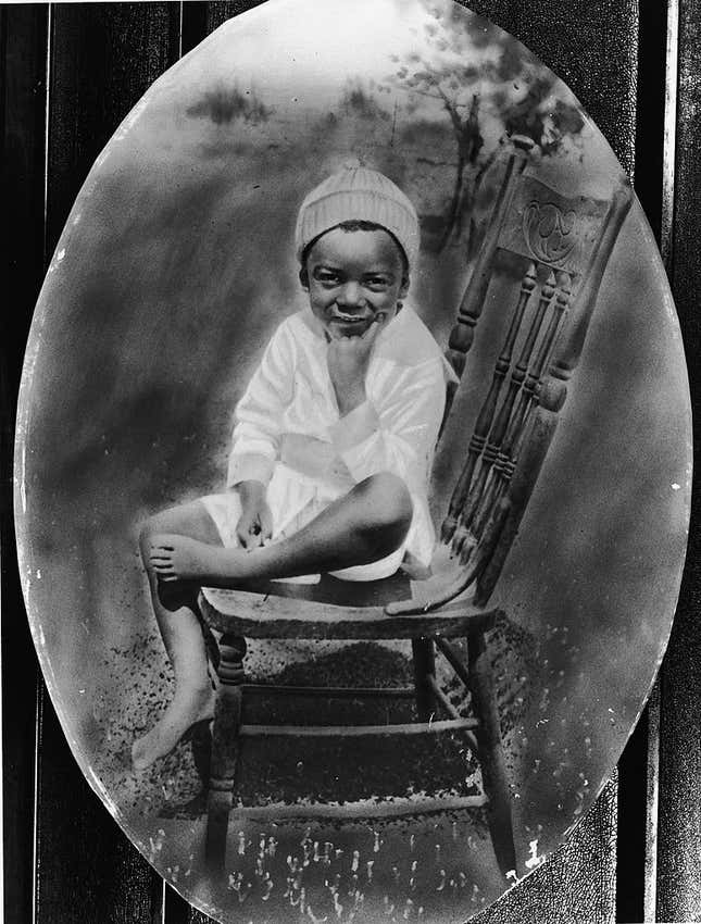 Oval-shaped portrait of a American baseball player Jackie Robinson as a young boy sitting on a chair, circa 1925.