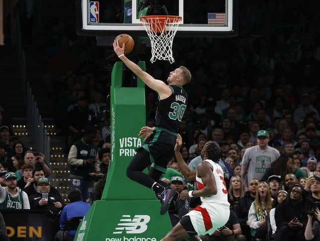 Apr 7, 2023; Boston, Massachusetts, USA; Boston Celtics forward Sam Hauser (30) goes past Toronto Raptors forward O.G. Anunoby (3) for a basket during the first quarter at TD Garden.