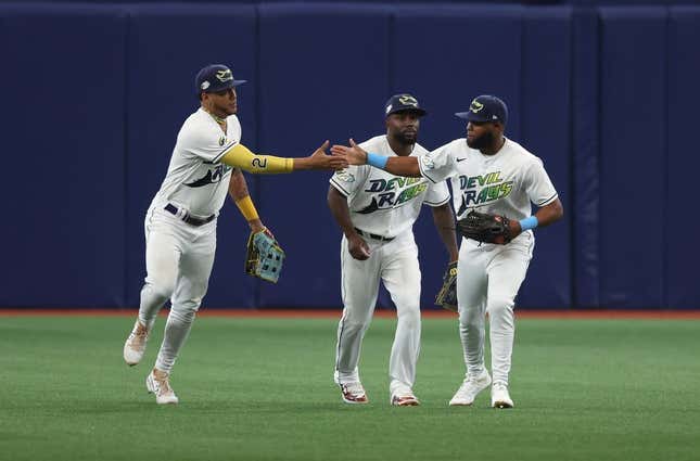 Mar 30, 2023; St. Petersburg, Florida, USA; Tampa Bay Rays center fielder Jose Siri (22), left fielder Randy Arozarena (56) and right fielder Manuel Margot (13) celebrate after they beat the Detroit Tigers at Tropicana Field.