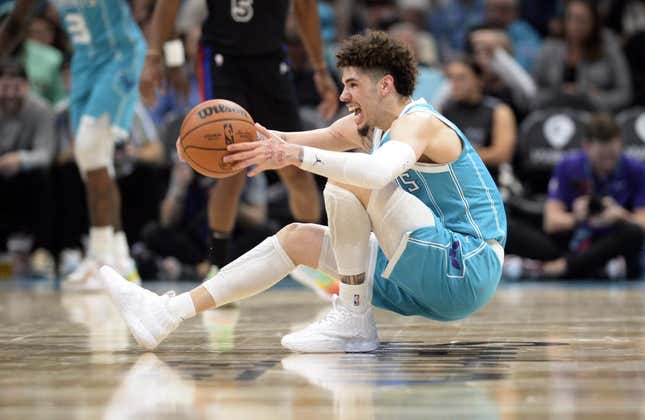 Feb 27, 2023; Charlotte, North Carolina, USA; Charlotte Hornets guard LaMelo Ball (1) controls the ball as he falls down during play during the second half against the Detroit Pistons at the Spectrum Center.
