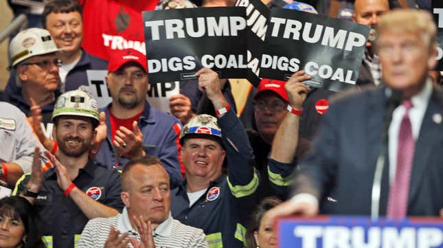In this May 5, 2016 photo, Coal miners wave signs as Republican presidential candidate Donald Trump speaks during a rally in Charleston, W.Va. Trump's election could signal the end of many of President Barack Obama's signature environmental initiatives. Trump has said he loathes regulation and wants to use more coal and expand offshore drilling and hydraulic fracturing.