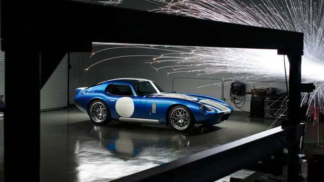 A photo showing sparks flying around a blue Renovo Coupe electric car. 