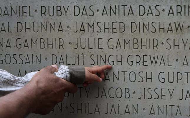 An Indo-Canadian woman shows her two-year-old grandson where the name of her husband and his grandfather, Daljit Singh Grewal, is located on a monument during a memorial marking the 25th anniversary of the Air India bombing in Vancouver, B.C., in June 2010.