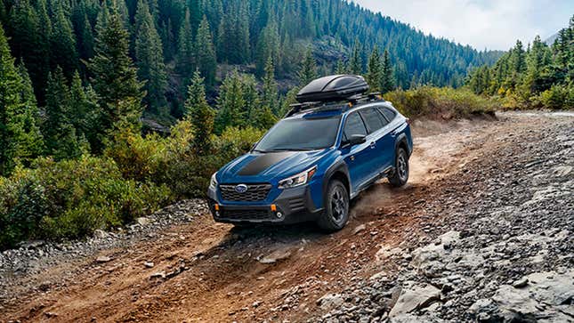 A blue Subaru Outback is modified to go off road. 