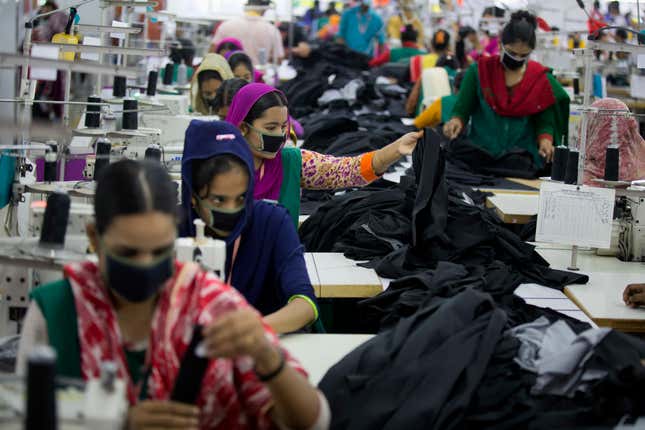 In this April 19, 2018 photo, Bangladeshis work at Snowtex garment factory in Dhamrai, near Dhaka, Bangladesh. A new survey says that five years after the Rana Plaza garment factory building collapse in Bangladesh killed 1,134 people and left thousands injured some things have changed for the better for the workers who toiled in the country's huge garment industry but much remains to be done. The survey by the Center for Business and Human Rights at New York University's Stern School of Business found that the largest factories generally have complied with new safety standards set by foreign clothing brands since the 2013 accident. (AP Photo/A.M. Ahad)