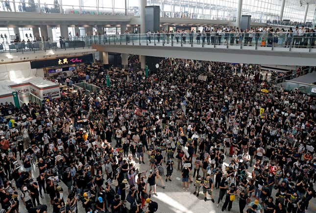 Protesters attend a mass demonstration at Hong Kong International Airport, Aug. 12, 2019.