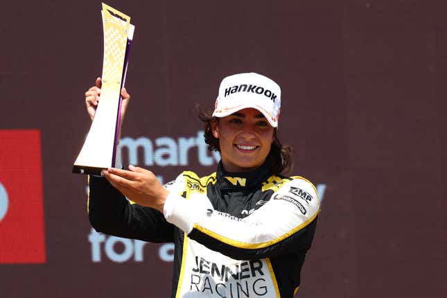 Three-time W Series champion Jamie Chadwick celebrates on podium during the series’ 2022 French race.