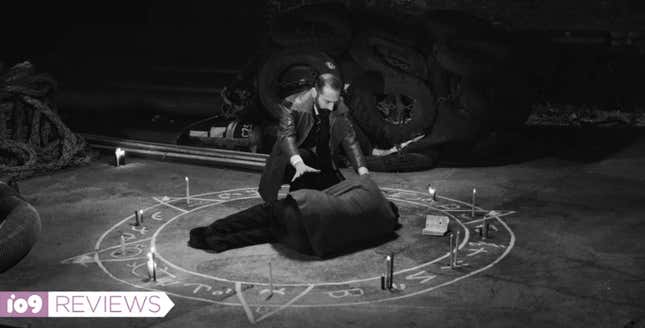A bearded man crouches over another man in a magic circle