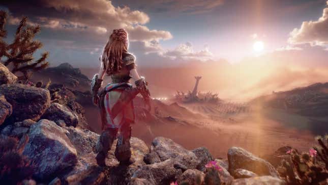 A screenshot from Horizon Forbidden West's January 19 story trailer depicting protagonist Aloy looking at a skyscraper-sized machine in the distance.